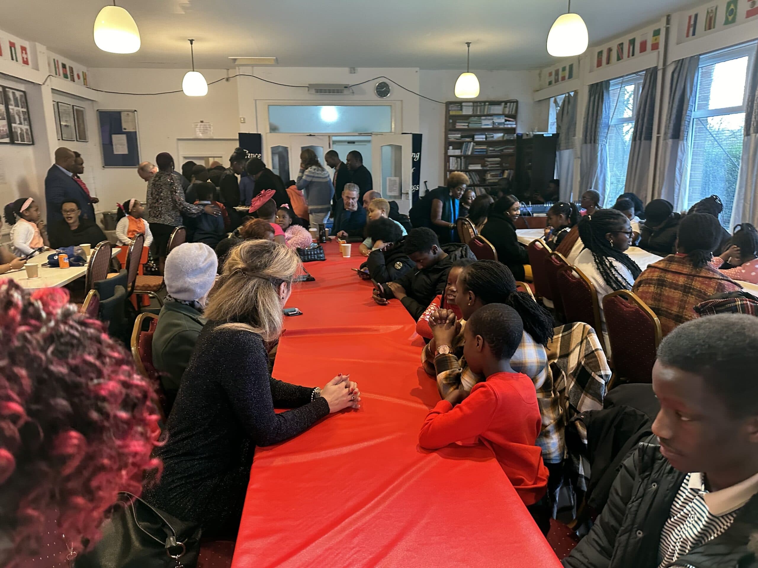 Three asylum seekers - one with a backpack, one with a handbag, and one with a green hoodie